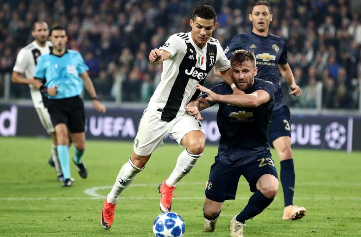 Pemain Juventus, Cristiano Ronaldo (kiri) mencoba melewati pemain Manchester United, Luke Shaw saat babak penyisihan grup H Liga Champions di Stadion Allianz, Turin (7/11/2018) (AFP). 