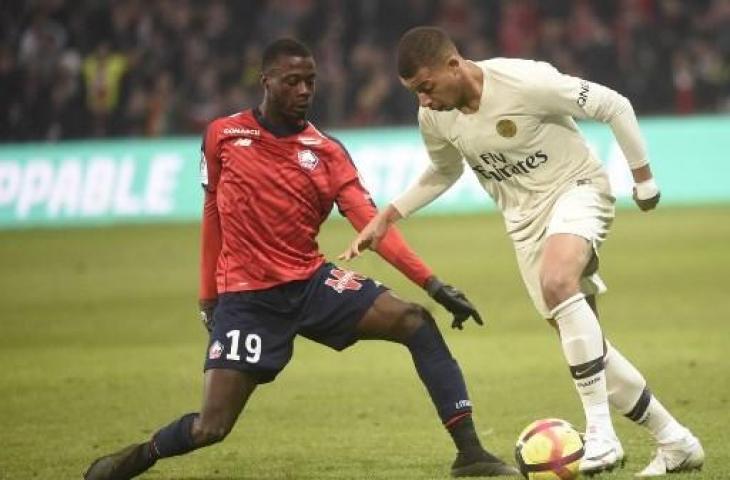 Aksi striker Paris Saint-Germain, Kylian Mbappe saat melawan Lille dalam lanjutan Ligue 1 di Stadion Pierre-Mauroy, Senin (15/4/2019) dini hari WIB. (FRANCOIS LO PRESTI / AFP)