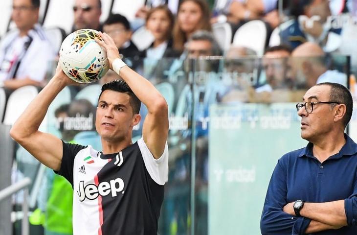 Pelatih Juventus, Maurizio Sarri tampak memperhatikan Cristiano Ronaldo yang sedang bersiap melakukan lemparan bola ke dalam pada laga Juventus kontra SPAL, Sabtu (28/9/2019). [ANDREAS SOLARO / AFP]