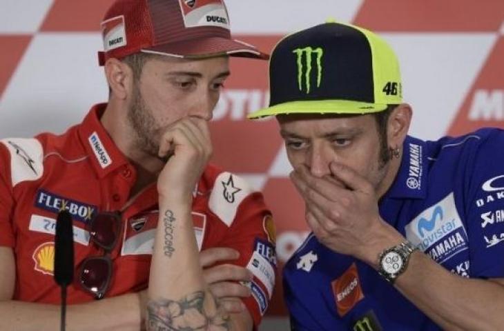 Pembalap Ducati, Andrea Dovizioso (kiri) saat berbincang dengan Valentino Rossi (Movistar Yamaha) dalam sebuah kesempatan. [AFP / Juan Mabromata]