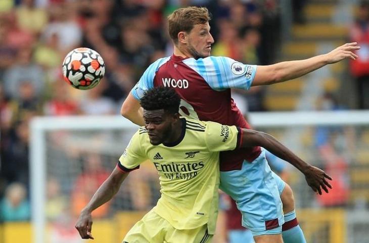 Pemain Arsenal Thomas Partley dan pemain Burnley Chris Wood di Liga Inggris, Sabtu (!8/9/2021). (AFP/Lindsey Parnabty)