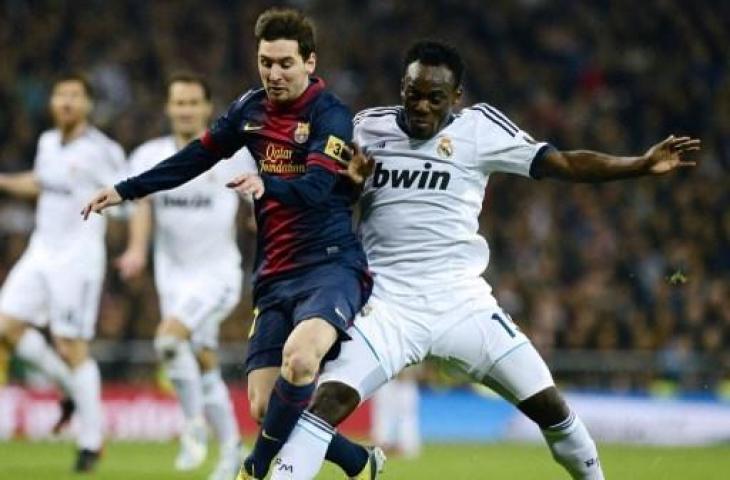 Michael Essien saat berduel dengan Lionel Messi. (JAVIER SORIANO / AFP)