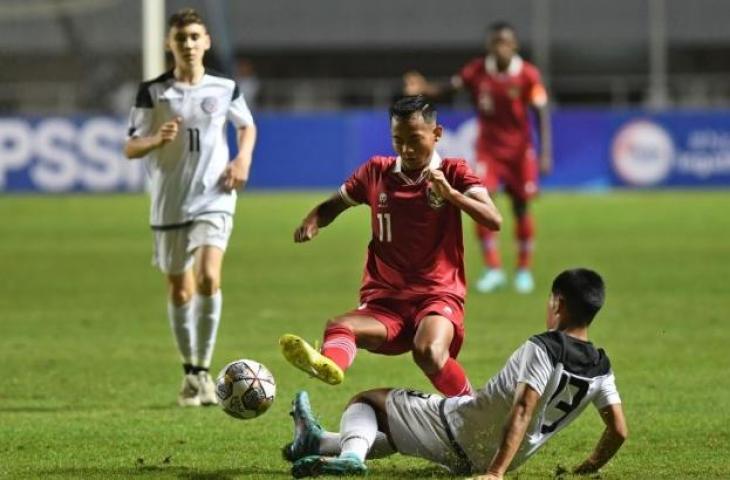 Pesepak bola Tim Nasional U-16 Indonesia Riski Afrisal (atas) berebut bola dengan pesepak bola Guam Nicholas Moore (bawah) dalam laga Grup B Kualifikasi Piala Asia U-17 2023 di Stadion Pakansari, Cibinong, Kabupaten Bogor, Jawa Barat, Senin (3/10/2022). ANTARA FOTO/Aditya Pradana Putra/foc.