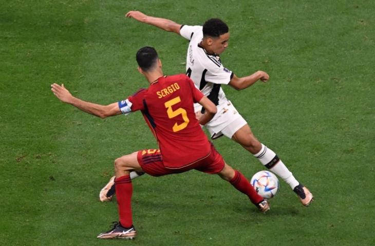 Gelandang Spanyol, Sergio Busquets, menandai gelandang Jerman, Jamal Musiala, selama pertandingan Grup E Piala Dunia Qatar 2022 antara Spanyol dan Jerman di Stadion Al-Bayt di Al Khor, utara Doha pada 27 November 2022. (AFP/Kirill Kudryavtsev)