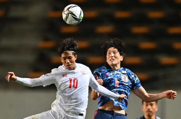 Penyerang Myanmar Win Naing Tun (Kiri) berebut bola dengan gelandang Jepang Genki Haraguchi selama laga kualifikasi Piala Dunia 2022 Grup F zona Asia di arena Fukuda Denshi di Chiba pada 28 Mei 2021. (AFP/Charly Triballeau)