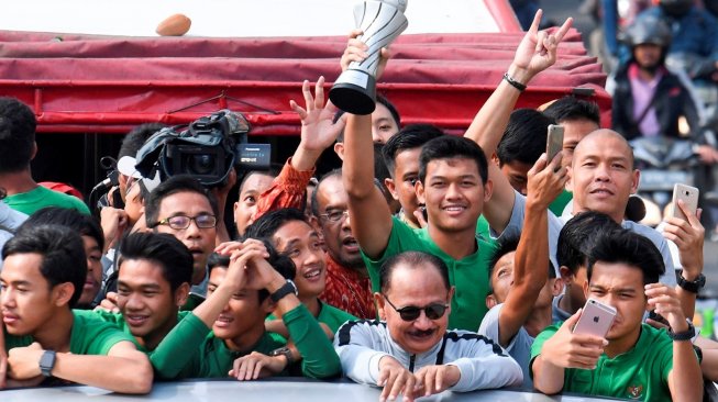 Pemain dan ofisial Timnas U-22 Indonesia menaiki bus tingkat ketika mengikuti konvoi menuju Istana Negara saat melintas di Jalan Sudirman, Jakarta, Kamis (28/2/2019). Konvoi timnas U-22 dari Hotel Sultan menuju Istana Negara itu digelar untuk merayakan keberhasilan skuat Garuda Muda menjuarai Piala AFF U-22 di Kamboja. ANTARA FOTO/Hafidz Mubarak A