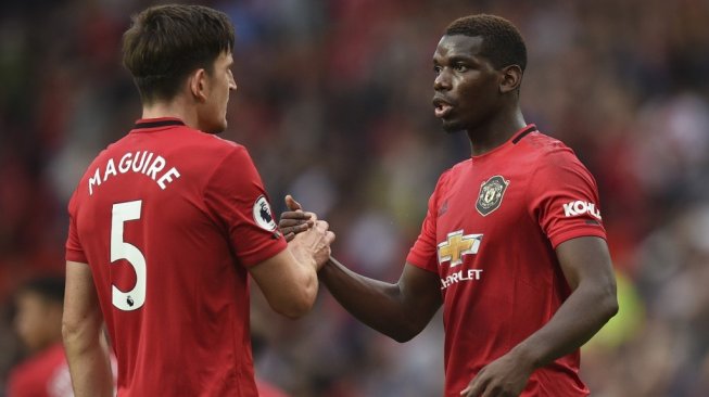 Gelandang Manchester United, Paul Pogba (kanan) dan centre-back Harry Maguire. [Oli SCARFF / AFP]