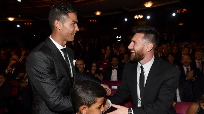 Cristiano Ronaldo (kiri) menajabat tangan Lionel Messi pada seremoni The Best FIFA Football Awards 2017 di London. [Ben STANSALL / AFP]