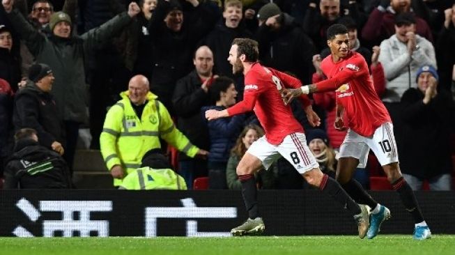 Gelandang Manchester United Juan Mata merayakan gol ke gawang Wolverhampton Wanderers bersama rekan setimnya Marcus Rashford pada laga replay Piala FA di Old Trafford. Paul ELLIS / AFP