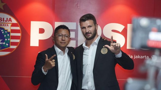 Presiden Persija Mohamad Prapanca (kiri) dan pemain anyar Persija Marco Motta (kanan) saat jumpa pers di Kantor Persija, Kuningan, Jakarta, Senin (3/2/2020). (dok. Persija). 