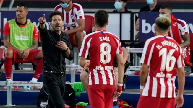 Pelatih Atletico Madrid Diego Simeone (kiri) berbicara kepada pemainnya saat menghadapi Levante dalam lanjutan Liga Spanyol. JOSE JORDAN / AFP