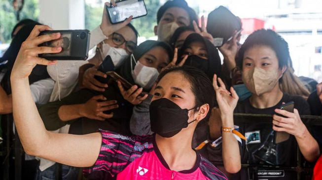 Pebulu tangkis tunggal putri Korea Selatan, An Se Young melakukan selfie bersama para penggemar di kawasan Istora Senayan, Jakarta. [BWF]